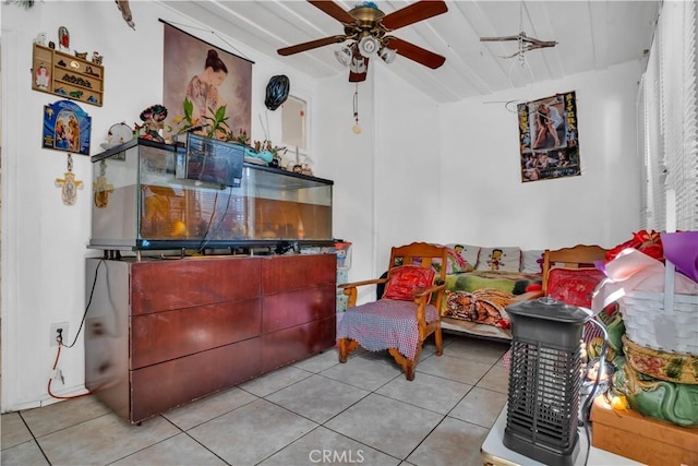 living room featuring ceiling fan, light tile patterned floors, and lofted ceiling with beams