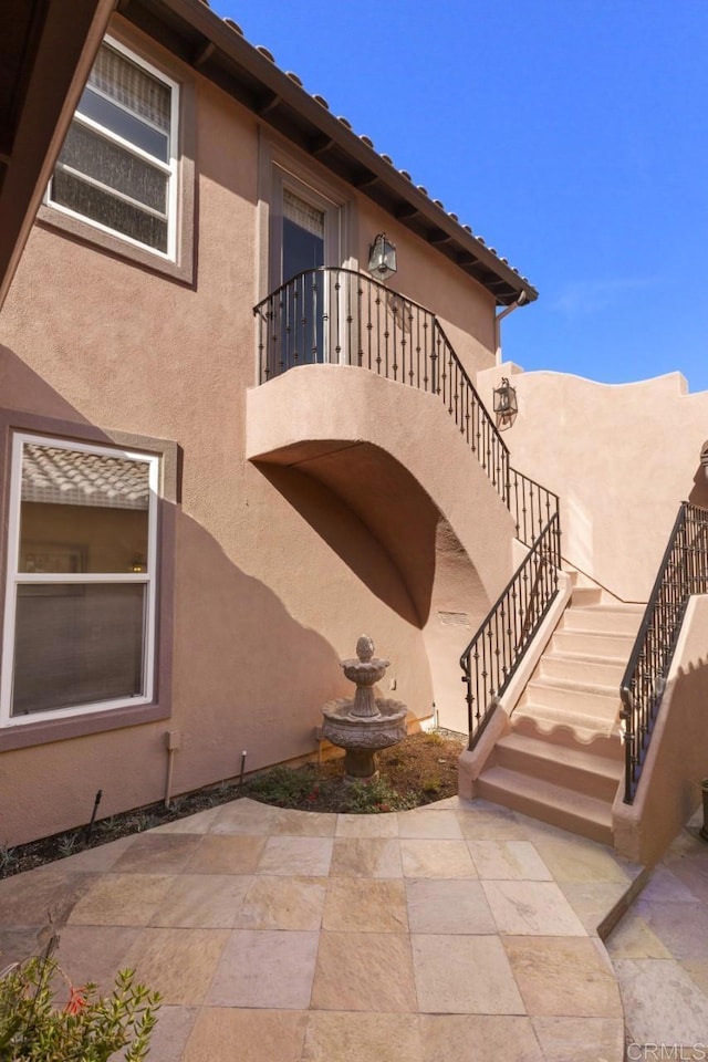 view of side of home with a patio area