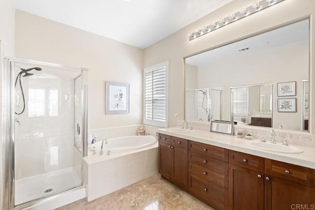 bathroom with vanity and shower with separate bathtub