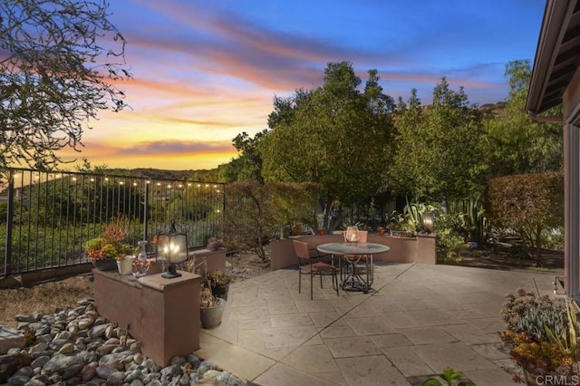 view of patio terrace at dusk