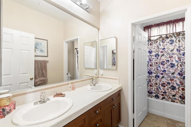 bathroom with shower / bath combo with shower curtain, vanity, and tile patterned flooring