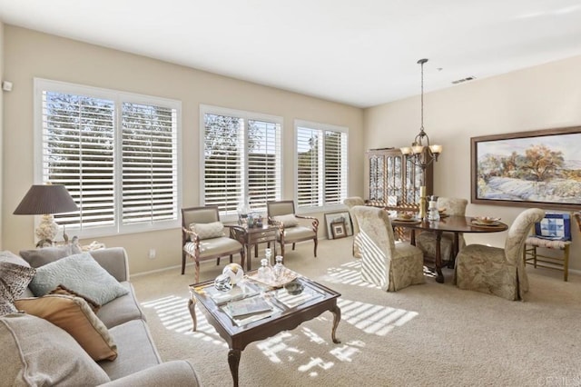 living room featuring a chandelier and light carpet