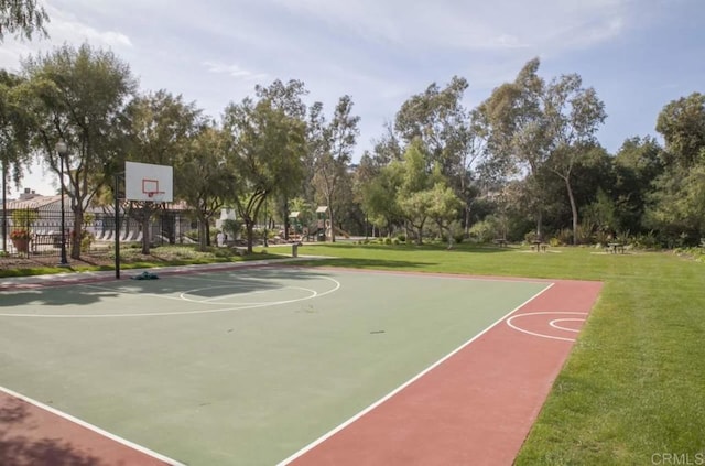 view of sport court with a yard