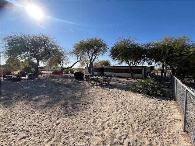 view of yard with fence and a fire pit