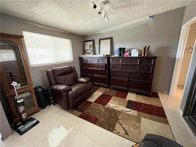 living area featuring a textured ceiling, light tile patterned floors, and radiator