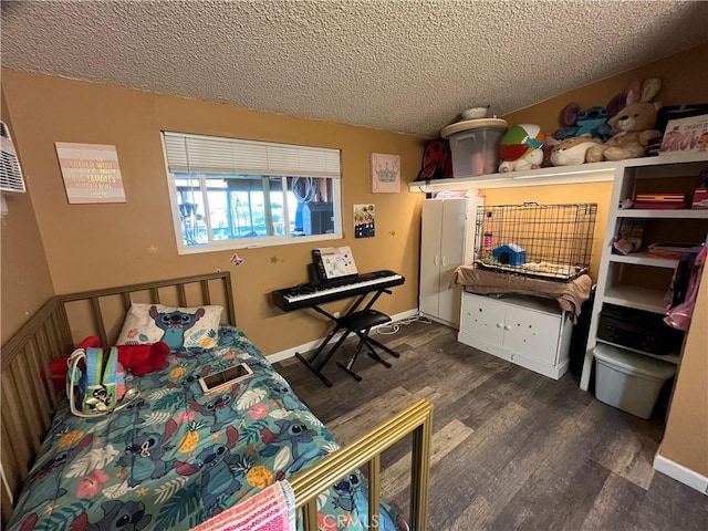 bedroom with baseboards, a textured ceiling, and wood finished floors