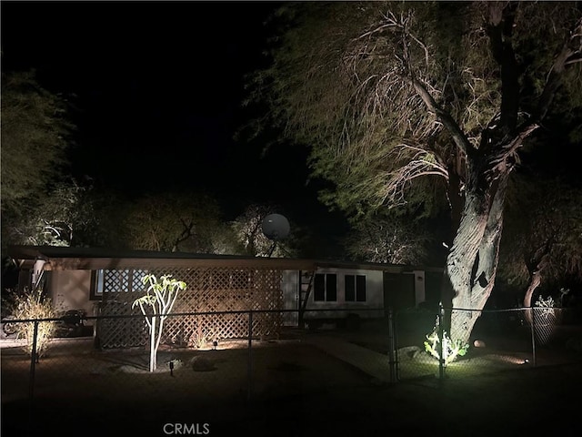 back of house at night with fence