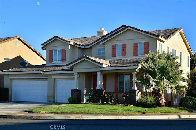 view of front of property featuring a porch, a garage, and a front lawn