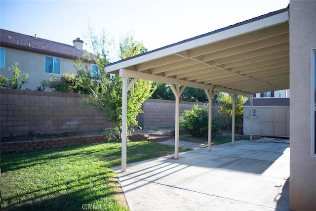 view of patio / terrace featuring a carport and a storage shed