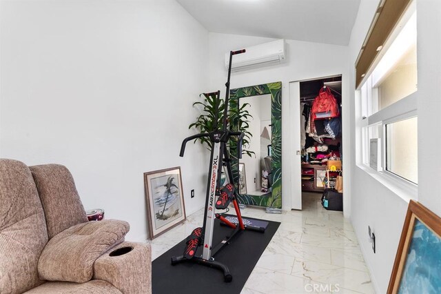 exercise room featuring lofted ceiling and a wall mounted AC