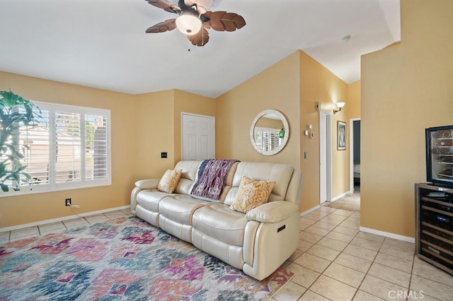 living room with light tile patterned floors, vaulted ceiling, ceiling fan, and beverage cooler