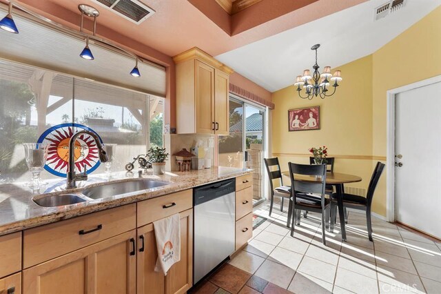 kitchen featuring light brown cabinetry, light stone counters, stainless steel dishwasher, sink, and a notable chandelier