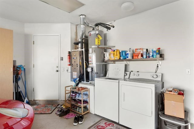 clothes washing area with strapped water heater and separate washer and dryer