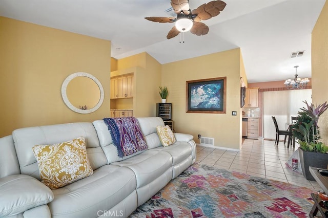 living room with light tile patterned floors and ceiling fan with notable chandelier