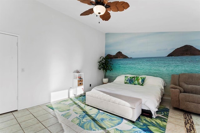 tiled bedroom with ceiling fan and lofted ceiling