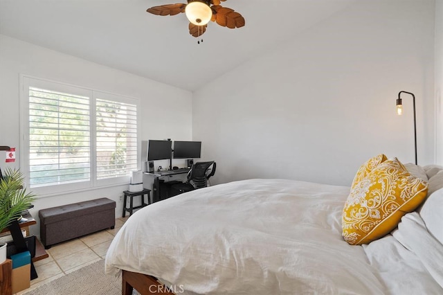 tiled bedroom with ceiling fan and lofted ceiling