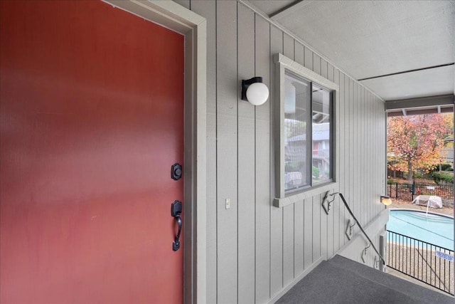 doorway to property featuring a fenced in pool