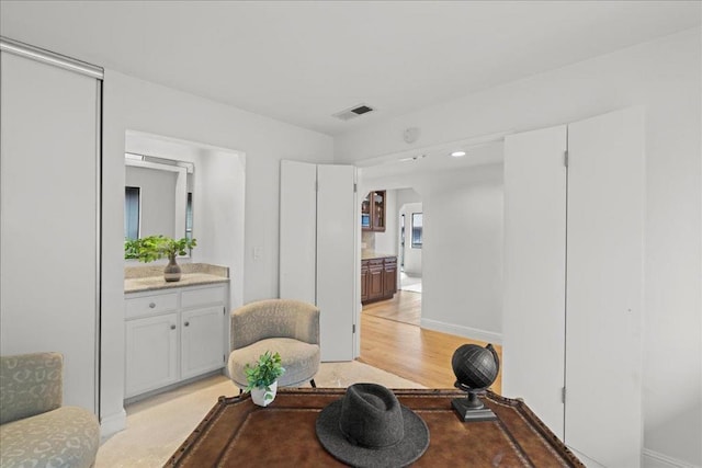 sitting room with light hardwood / wood-style flooring