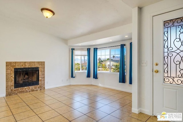 foyer entrance featuring a fireplace and light tile patterned floors