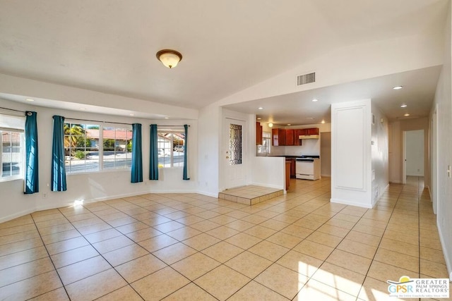 tiled empty room with vaulted ceiling