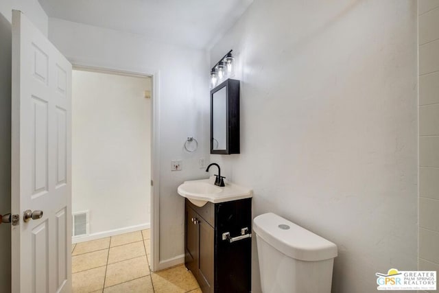 bathroom featuring tile patterned flooring, vanity, and toilet