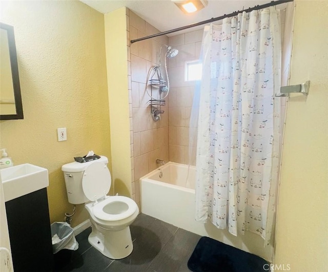 full bathroom with tile patterned floors, shower / bath combo with shower curtain, vanity, and toilet