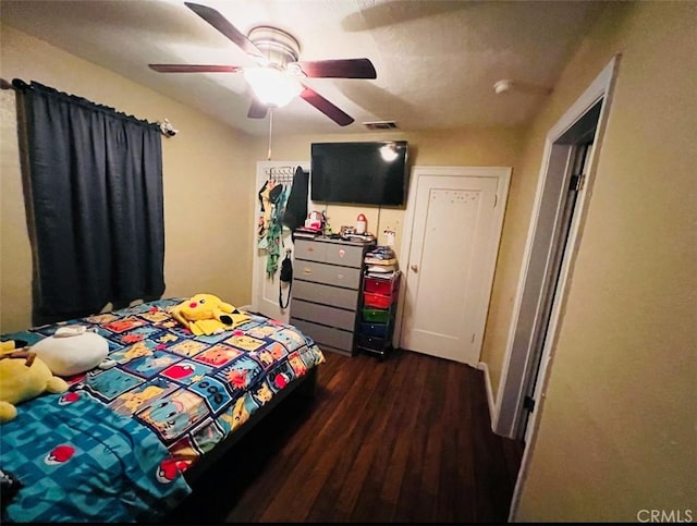 bedroom featuring ceiling fan and dark wood-type flooring