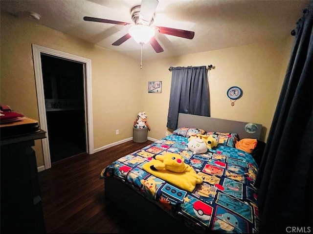 bedroom with dark hardwood / wood-style flooring and ceiling fan