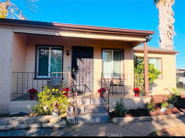 view of exterior entry with a porch