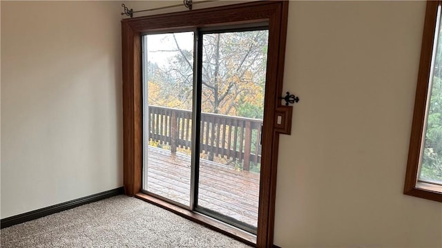 doorway to outside with carpet floors and plenty of natural light