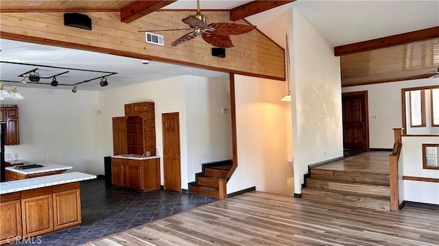 kitchen with ceiling fan, dark hardwood / wood-style flooring, beamed ceiling, and high vaulted ceiling