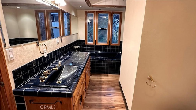 kitchen with tile countertops, sink, and dark wood-type flooring