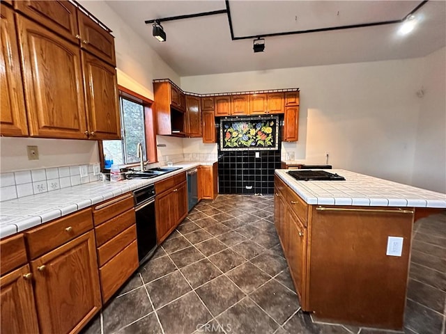 kitchen with tile countertops, sink, rail lighting, and stainless steel dishwasher