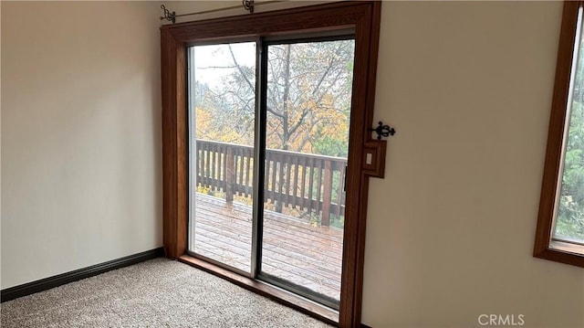 entryway featuring carpet and a healthy amount of sunlight