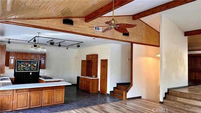 kitchen with pendant lighting, ceiling fan with notable chandelier, decorative backsplash, dark hardwood / wood-style flooring, and kitchen peninsula