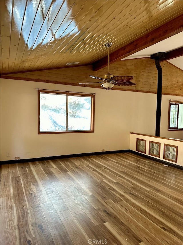 additional living space featuring hardwood / wood-style floors, vaulted ceiling with beams, and wood ceiling