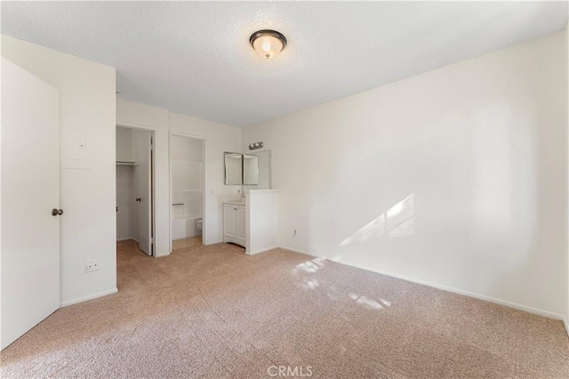 unfurnished bedroom featuring a closet and light colored carpet