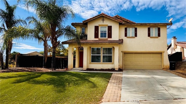 mediterranean / spanish-style house featuring a front lawn and a garage