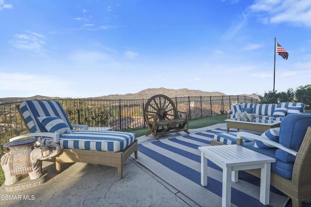 view of patio with a mountain view and an outdoor living space