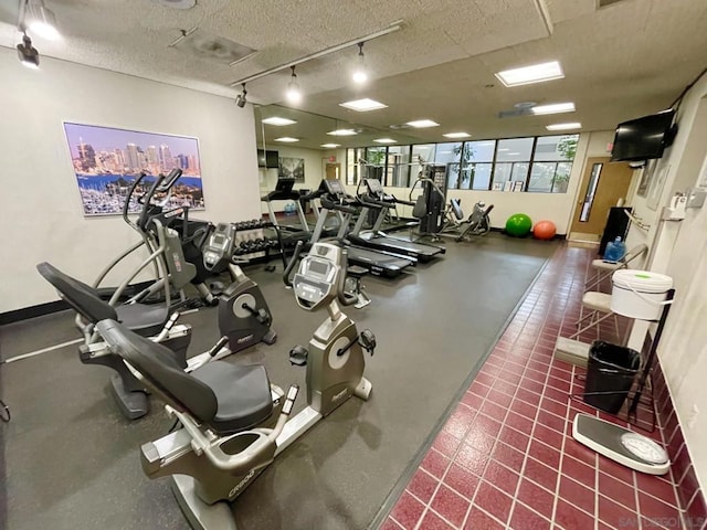 exercise room with a textured ceiling