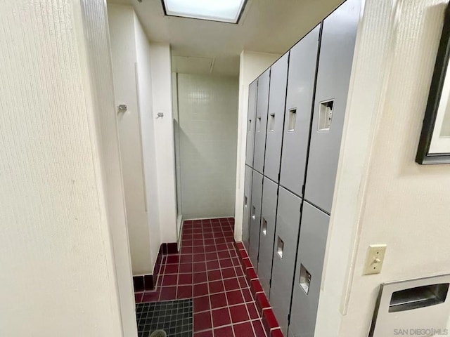 hall with dark tile patterned floors