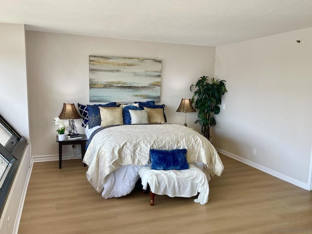 bedroom with hardwood / wood-style floors