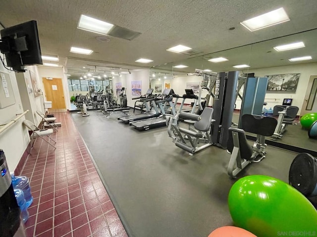 exercise room with a textured ceiling