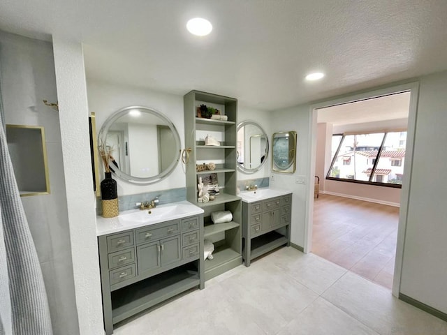 bathroom featuring vanity, wood-type flooring, and a textured ceiling