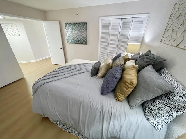 bedroom featuring hardwood / wood-style flooring and a closet