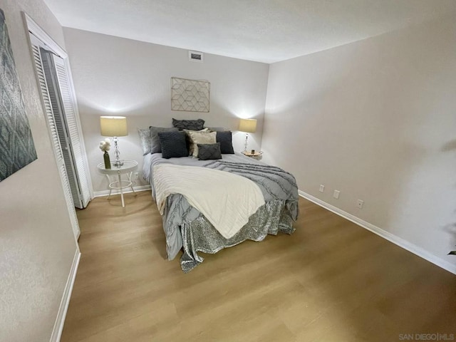 bedroom featuring light hardwood / wood-style floors and a closet