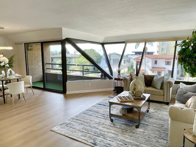 living room with wood-type flooring and a textured ceiling