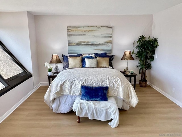 bedroom with wood-type flooring