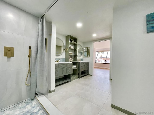 bathroom featuring tile patterned flooring, vanity, and curtained shower