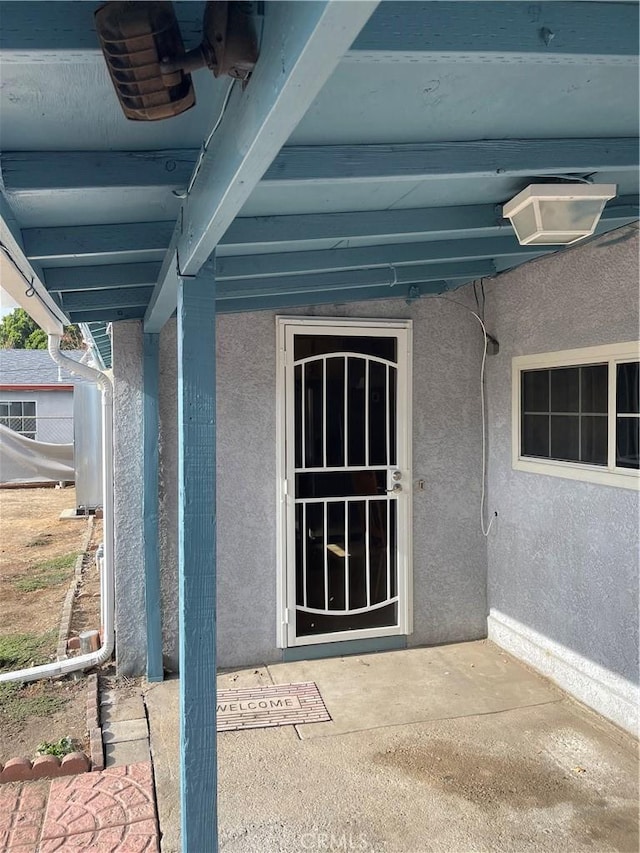 property entrance with a patio area